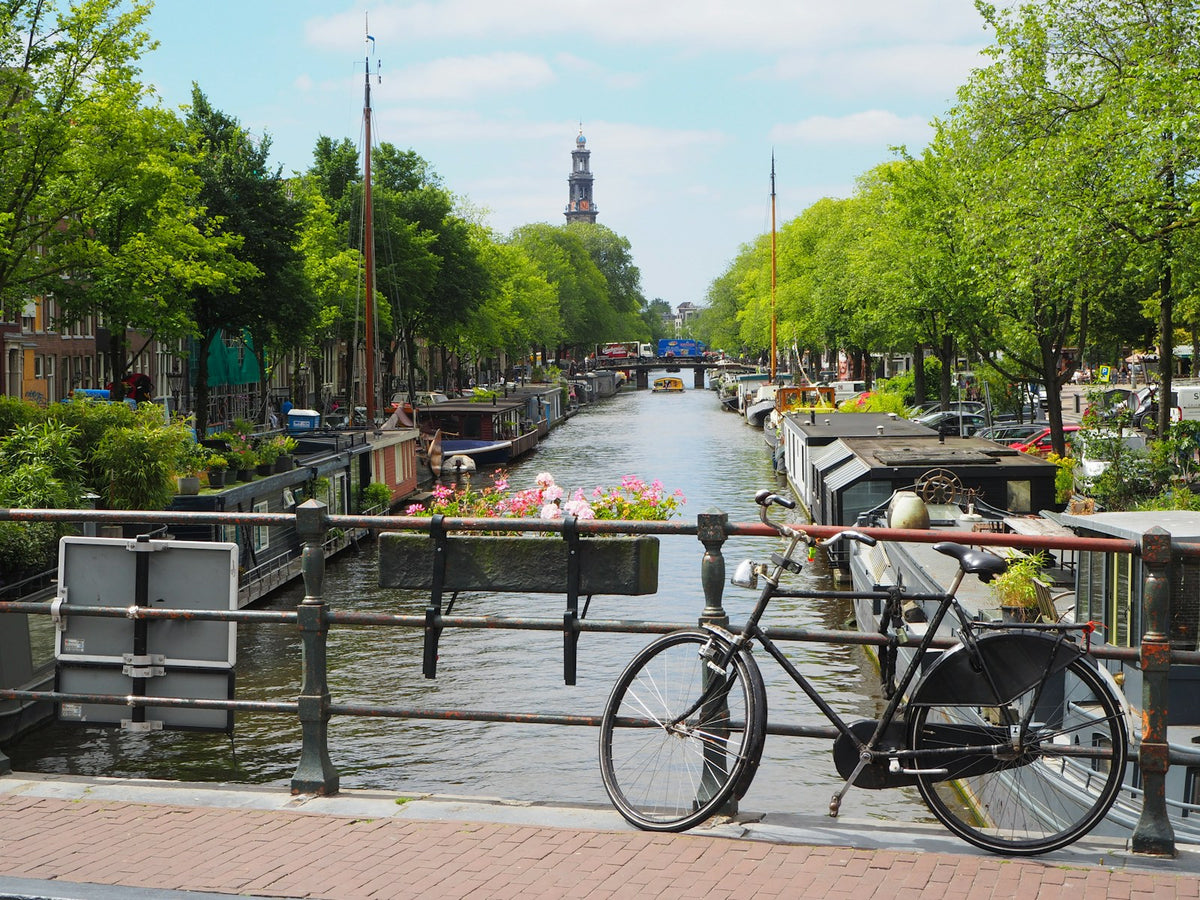 A city bicycle parked on a waterfront path, no rider